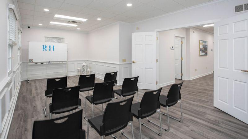Small group therapy room with chairs and whiteboard at Rolling Hills Recovery Center.