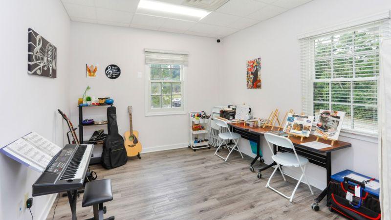 Art and music therapy room with instruments, art supplies, and creative workspace at Rolling Hills Recovery Center.