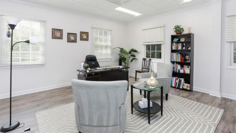 Clinical Director office with desk, bookshelves, chairs, and natural light at Rolling Hills Recovery Center.