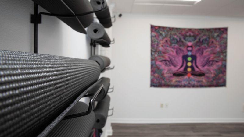 Yoga and meditation room with mats and chakra tapestry at Rolling Hills Recovery Center.